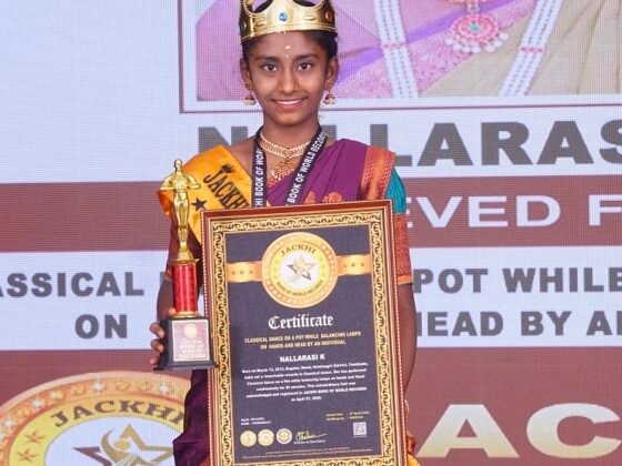 CLASSICAL DANCE ON A POT WHILE  BALANCING LAMPS ON  HANDS AND HEAD BY AN INDIVIDUAL