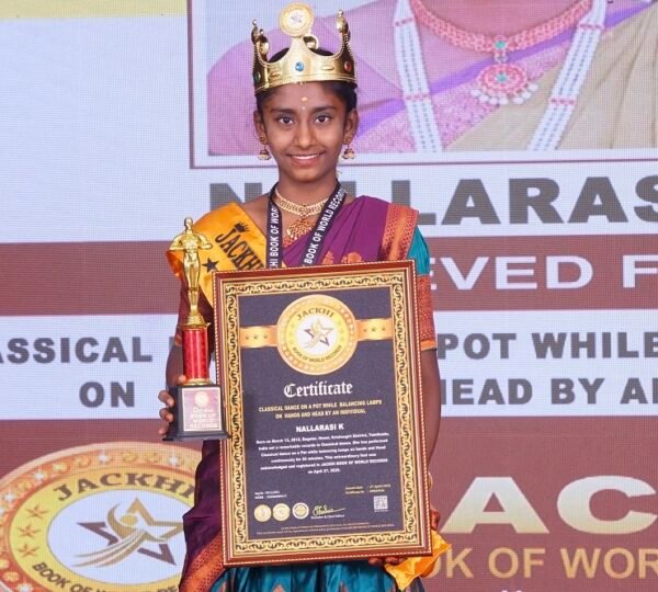 CLASSICAL DANCE ON A POT WHILE  BALANCING LAMPS ON  HANDS AND HEAD BY AN INDIVIDUAL